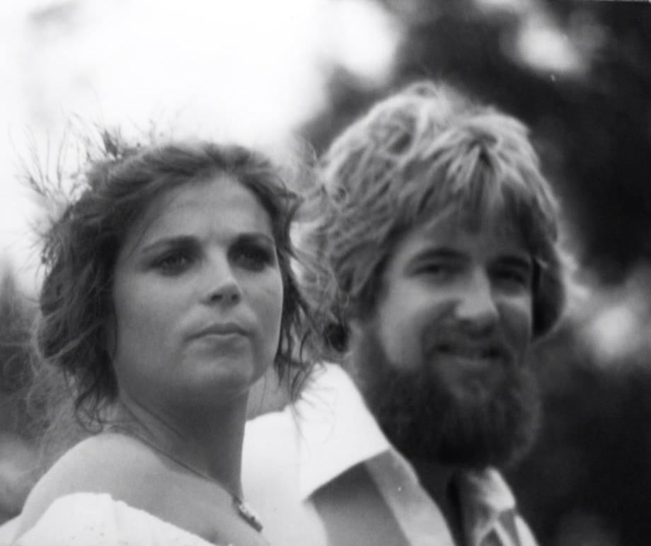 Black and white photo of a young Deborah beside her husband, bearded and smiling